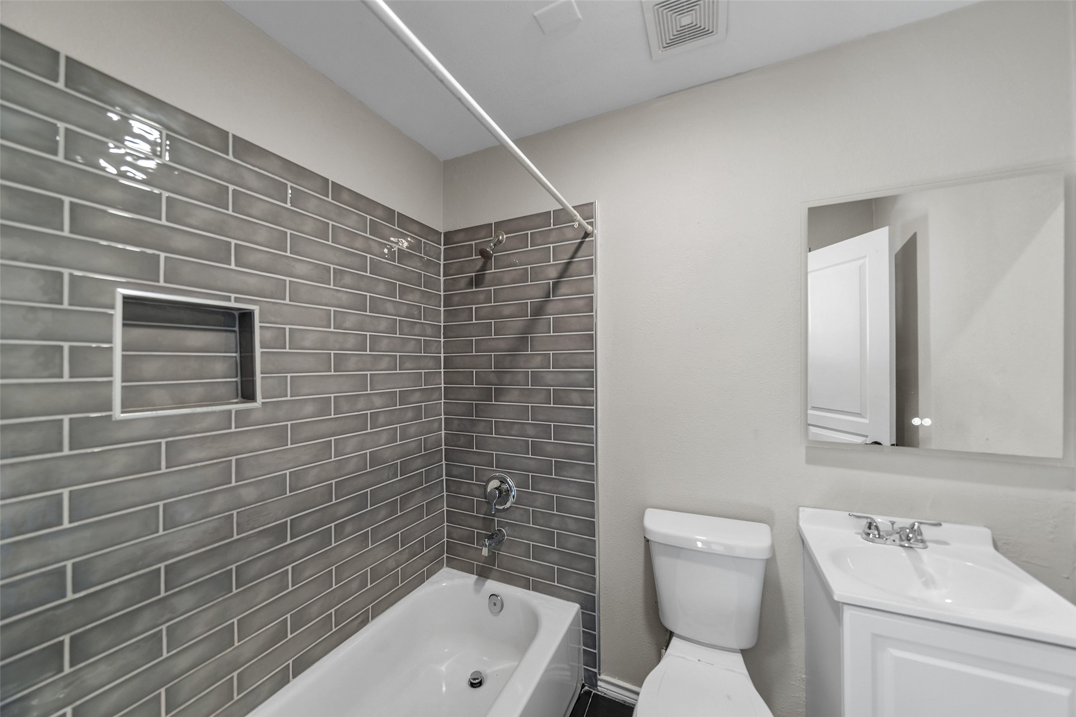 7019 Sur Court Houston, TX 77033 - Photo 17 of 22 a bathroom with a toilet sink and mirror