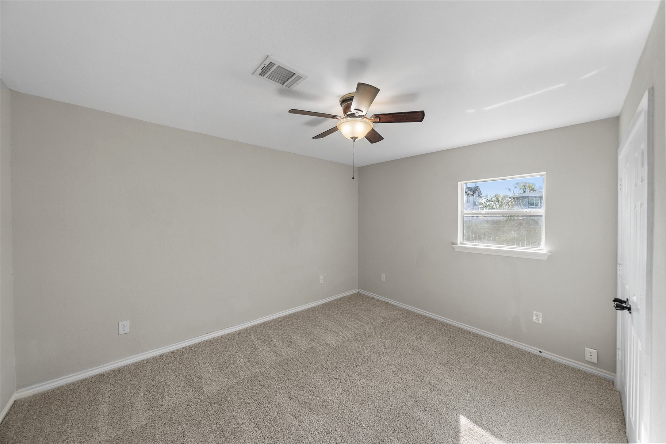 7019 Sur Court Houston, TX 77033 - Photo 18 of 22 an empty room with a window and a fan