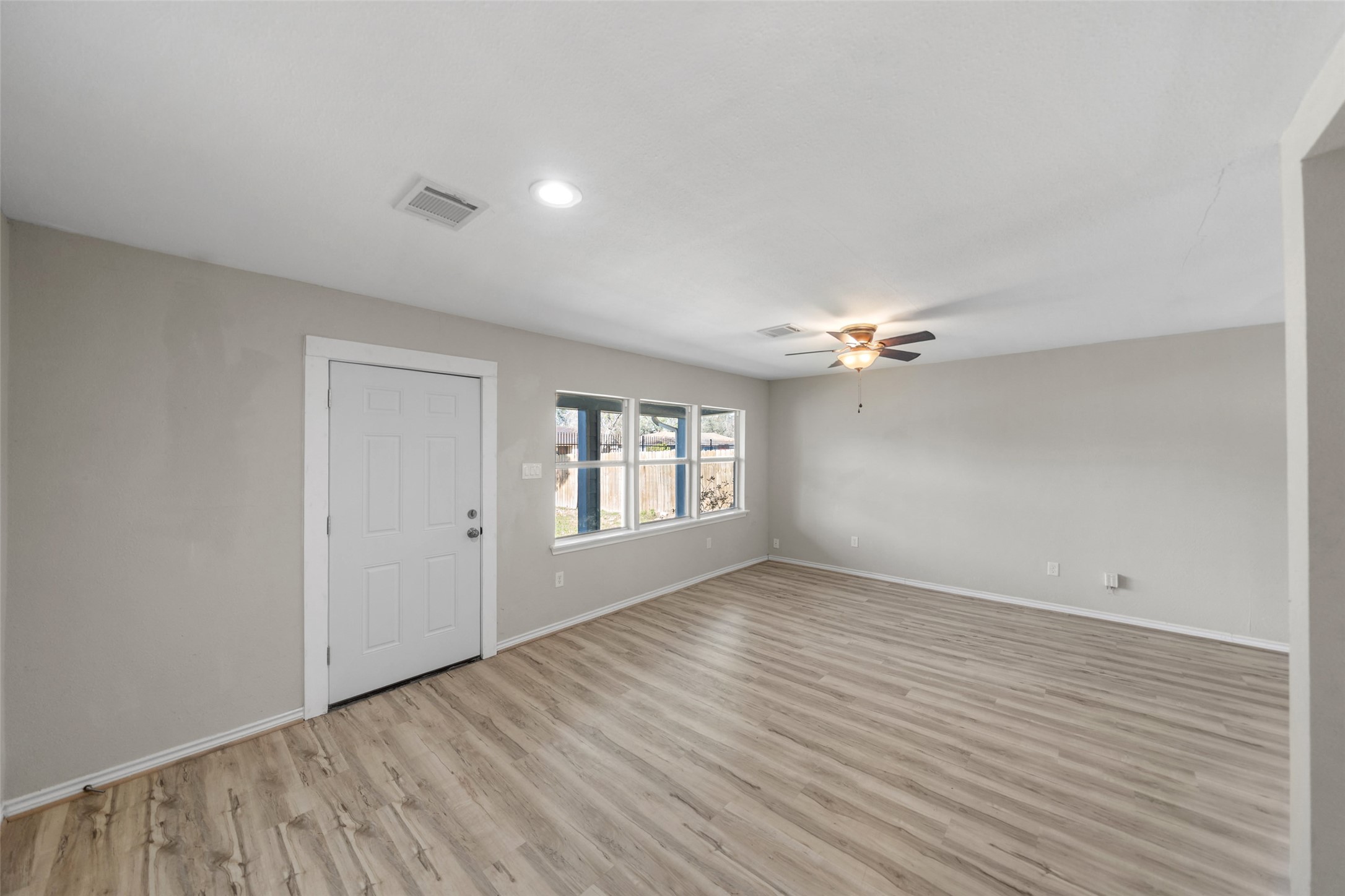 7019 Sur Court Houston, TX 77033 - Photo 3 of 22 wooden floor in an empty room with a window