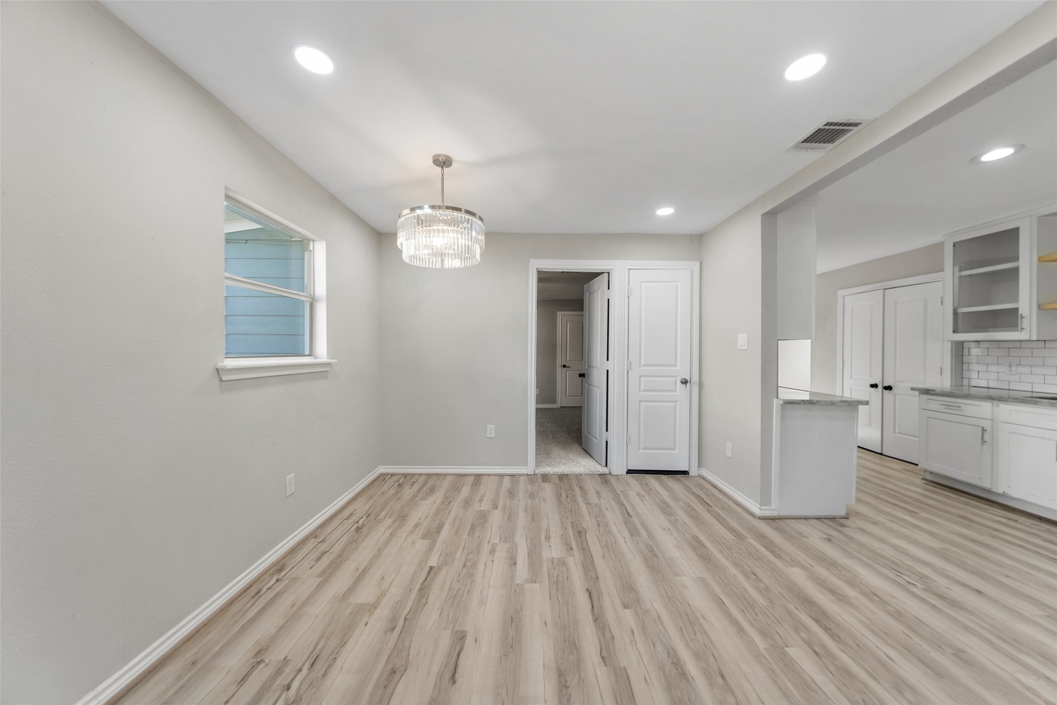 7019 Sur Court Houston, TX 77033 - Photo 5 of 22 an empty room with wooden floor and windows