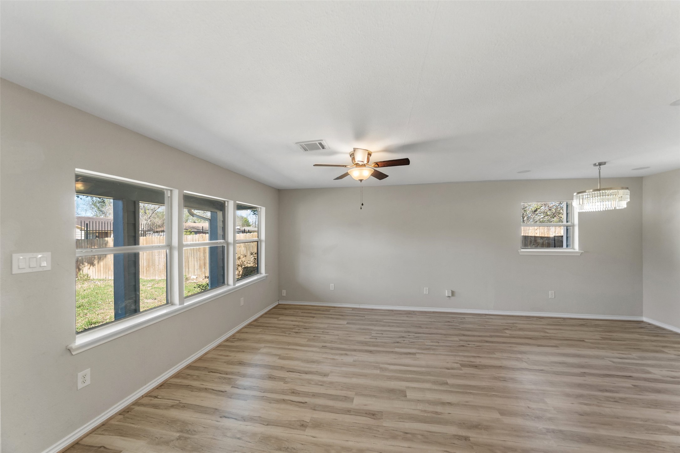 7019 Sur Court Houston, TX 77033 - Photo 6 of 22 a view of an empty room with a window and wooden floor