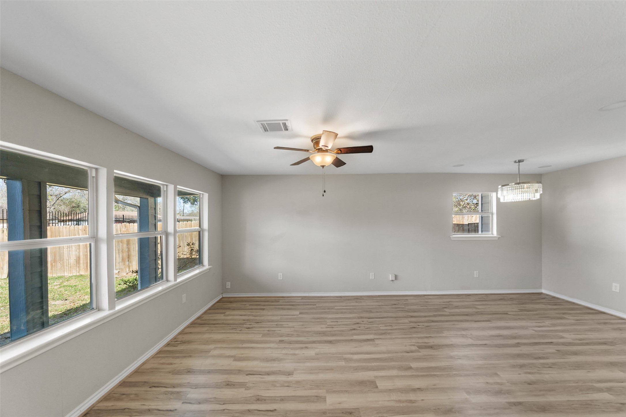 7019 Sur Court Houston, TX 77033 - Photo 7 of 22 a view of an empty room with a window and wooden floor