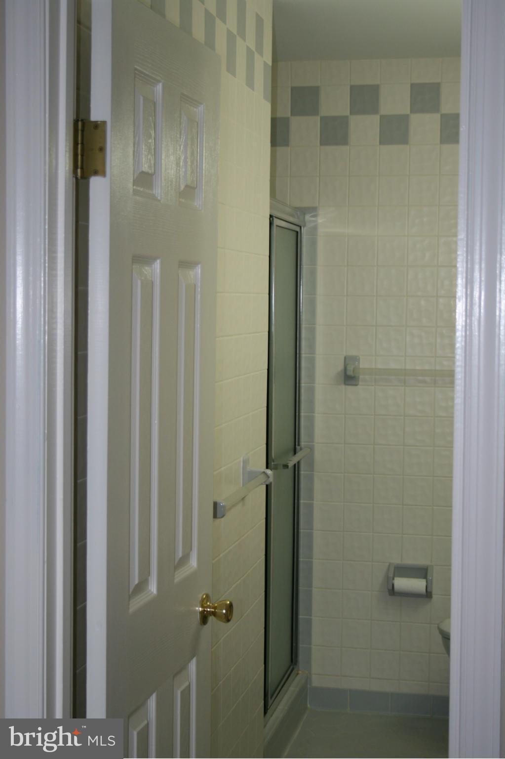 19116 Bloomfield Road Olney, MD 20832 - Photo 14 of 25 a bathroom with a glass door shower