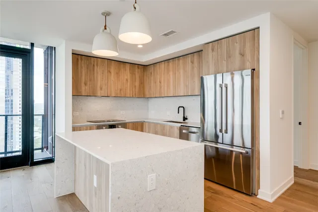 a kitchen with a refrigerator a sink and cabinets