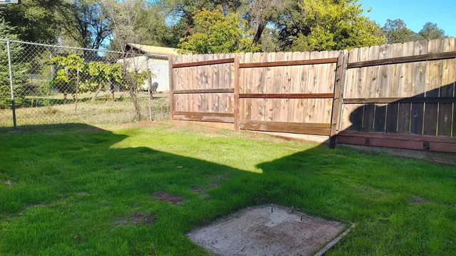 a view of a backyard with a garden and deck