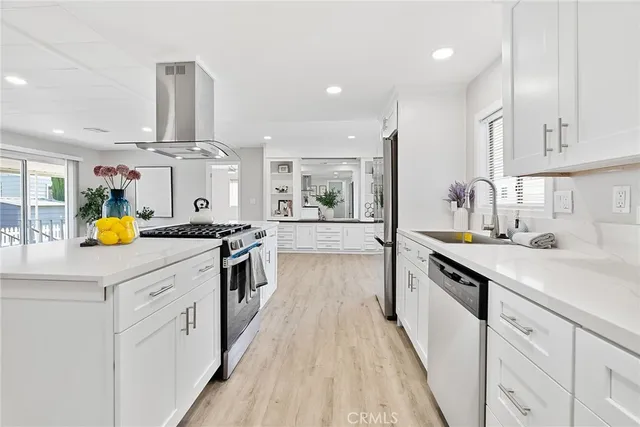 a kitchen with stainless steel appliances a sink stove and cabinets