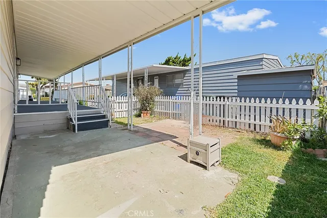 a view of a patio with a table and chairs