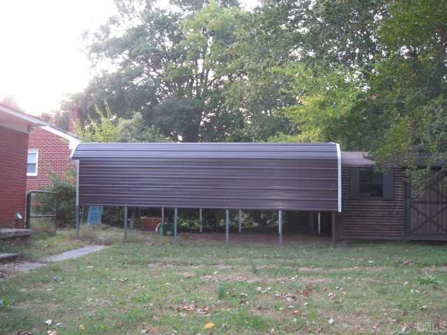 2407 Glascock Street Raleigh, NC 27610 - Photo 6 of 7 a wooden bench sitting in front of a house