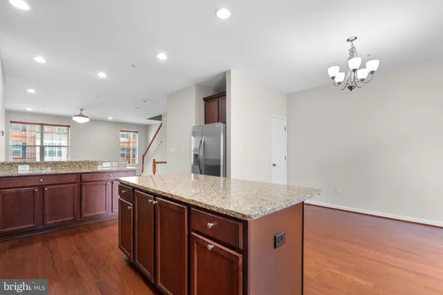 a kitchen with granite countertop cabinets a sink and dishwasher