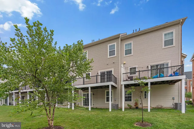 a view of an house with backyard porch and sitting area