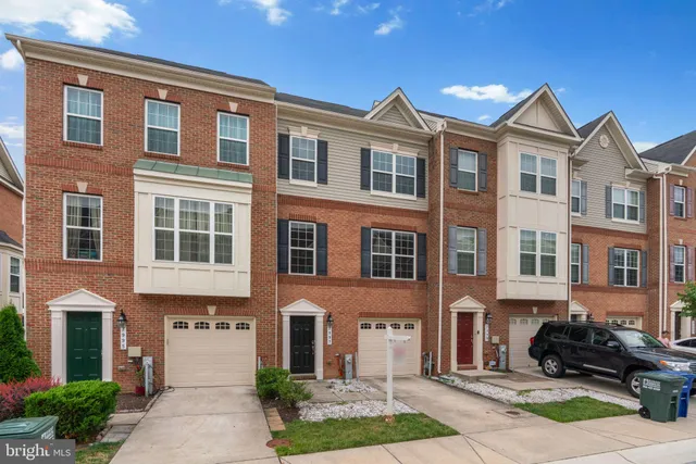 a front view of a residential apartment building with a yard