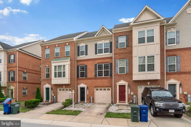 a front view of a residential apartment building with a yard