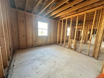 a view of a patio with a table and chairs and wooden fence