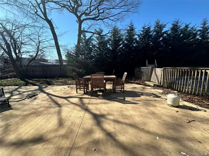 a black and white refrigerator freezer sitting in a backyard