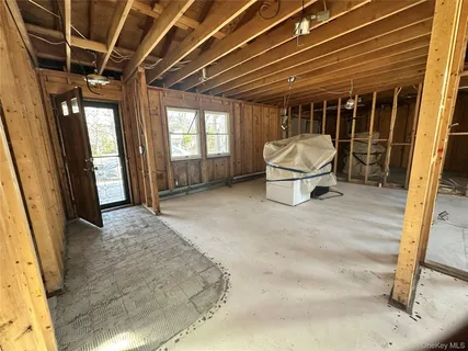 a view of a porch with furniture and a window