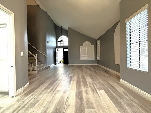a view of empty room with wooden floor