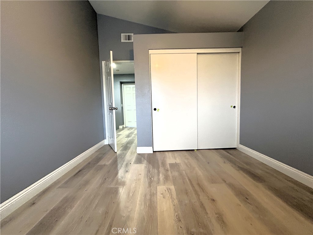 3773 Burning Tree Drive Ontario, CA 91761 - Photo 15 of 28 a view of an empty room with wooden floor and a window