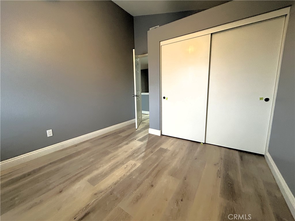 3773 Burning Tree Drive Ontario, CA 91761 - Photo 16 of 28 a view of an empty room with wooden floor and a window