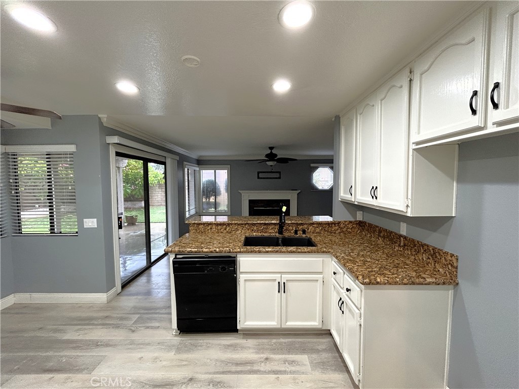 3773 Burning Tree Drive Ontario, CA 91761 - Photo 2 of 28 a kitchen with granite countertop a sink stove and cabinets