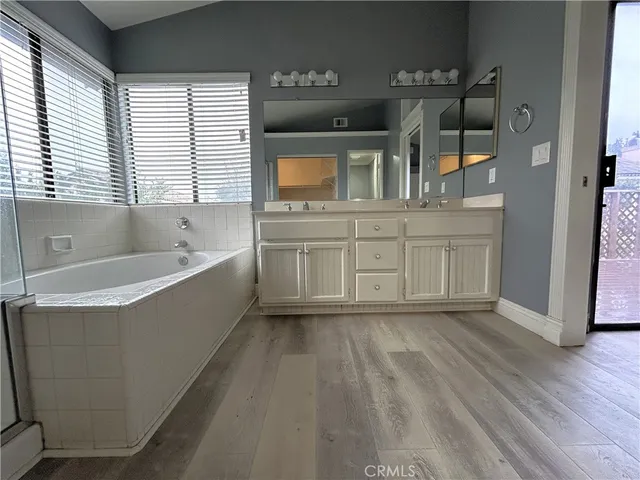 a spacious bathroom with a bathtub and a sink