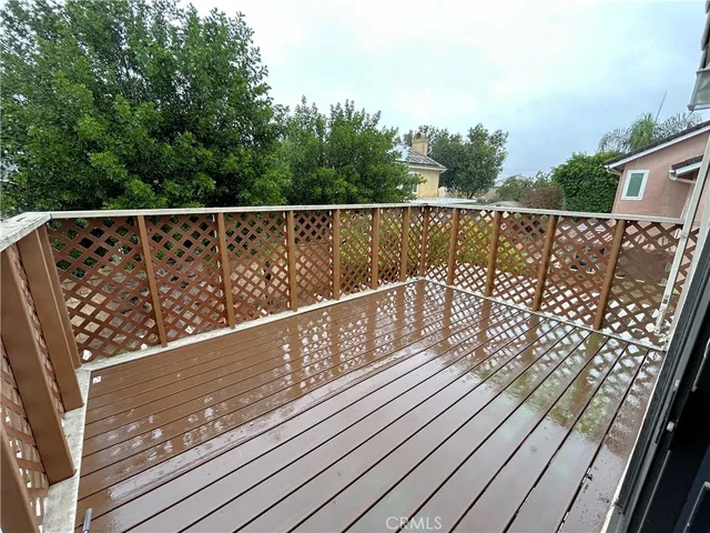 a view of balcony with wooden floor and fence