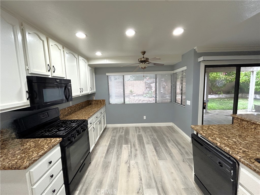 3773 Burning Tree Drive Ontario, CA 91761 - Photo 3 of 28 a kitchen with granite countertop a stove sink and cabinets