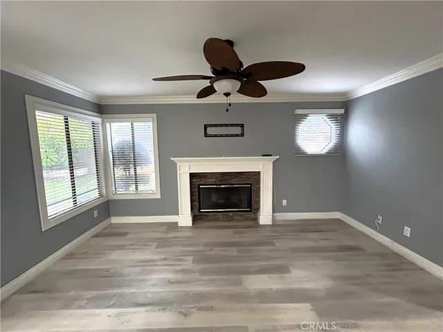 a view of an empty room with a fireplace and a window