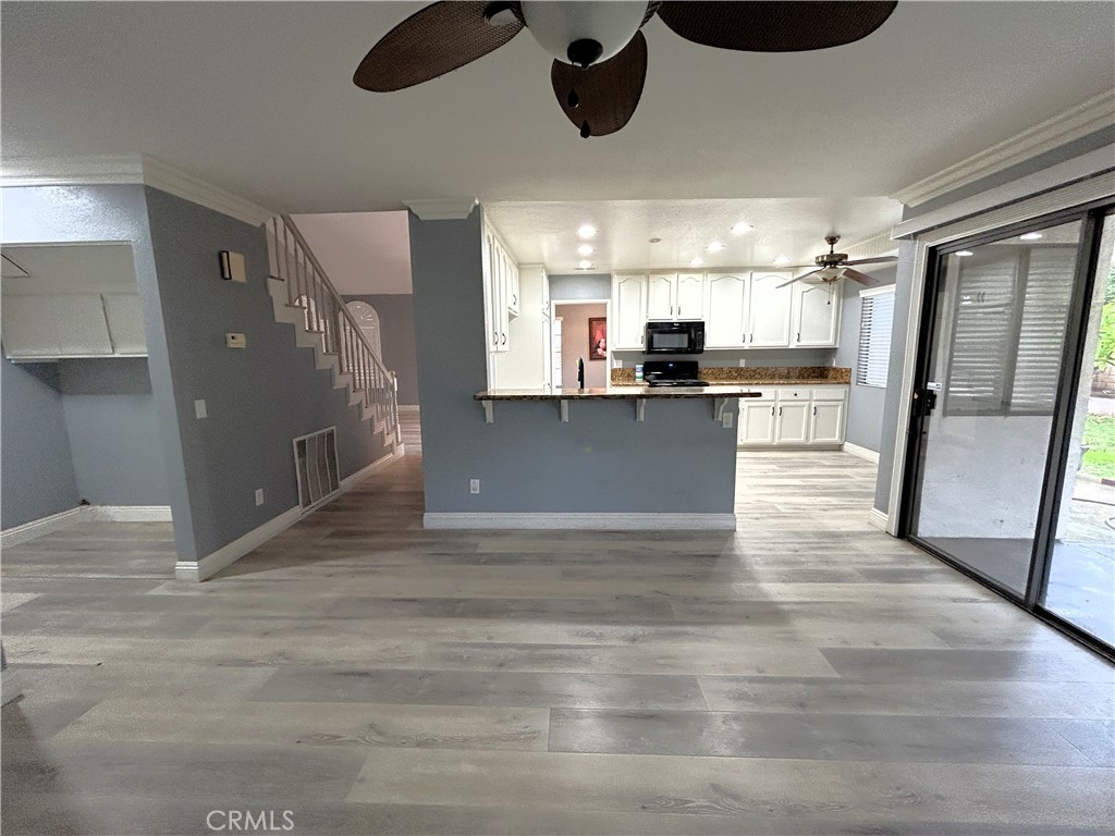 3773 Burning Tree Drive Ontario, CA 91761 - Photo 8 of 28 a view of a kitchen with a sink stainless steel appliances and cabinets