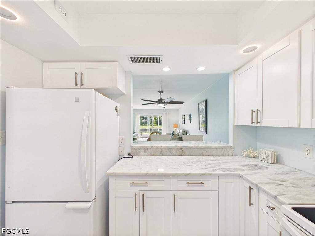 300 Valley Stream Drive, Unit 3D Naples, FL 34113 - Photo 11 of 21 a kitchen with a sink a stove a refrigerator and white cabinets