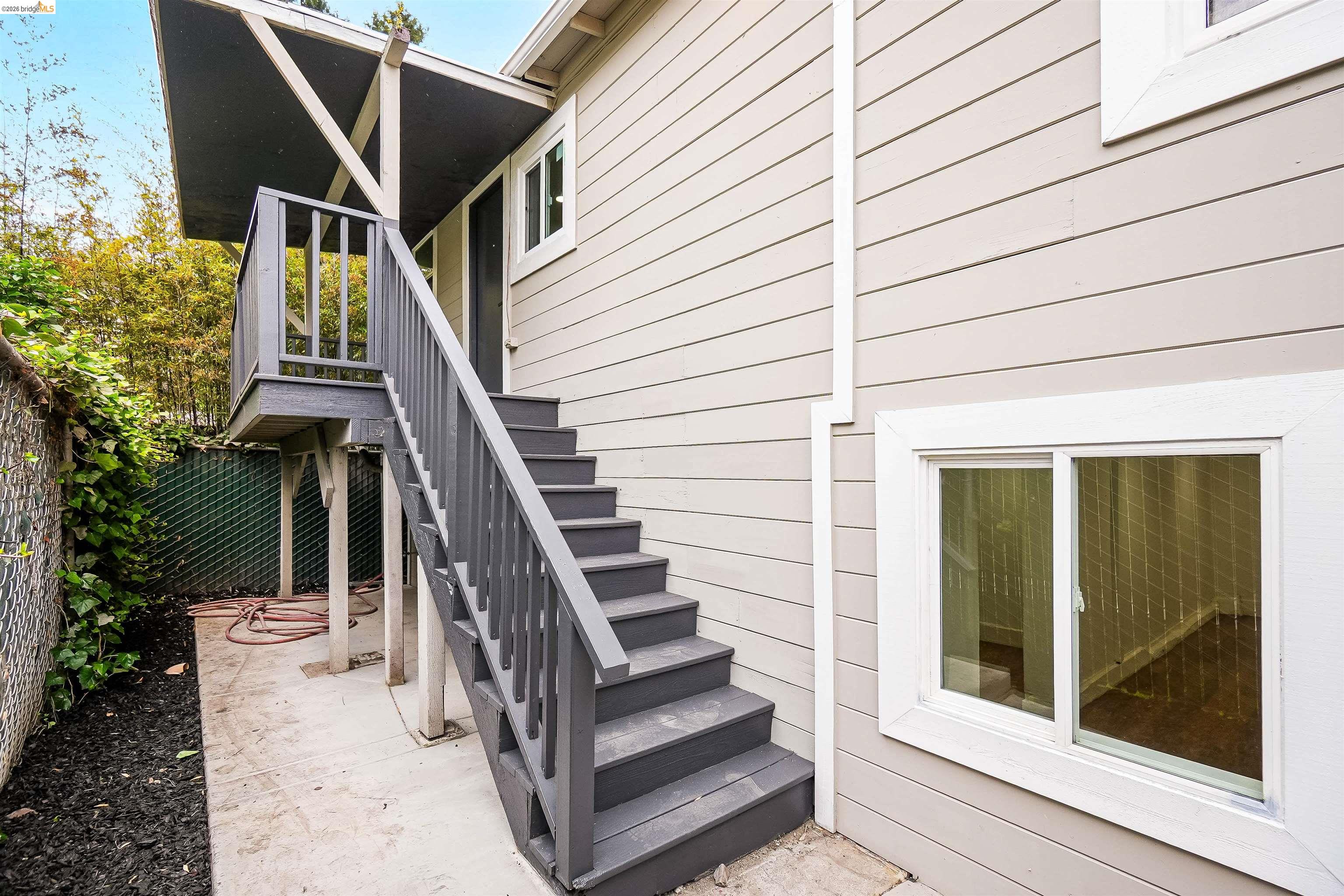 1812 Woolsey Street Berkeley, CA 94703 - Photo 28 of 48 Exterior featuring horizontal siding, white trim windows, and a multi-level deck and staircase with painted wood railings