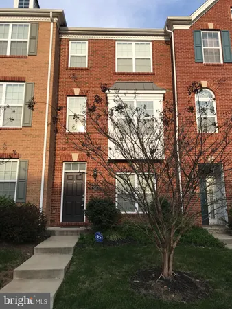 a view of a brick building next to a yard