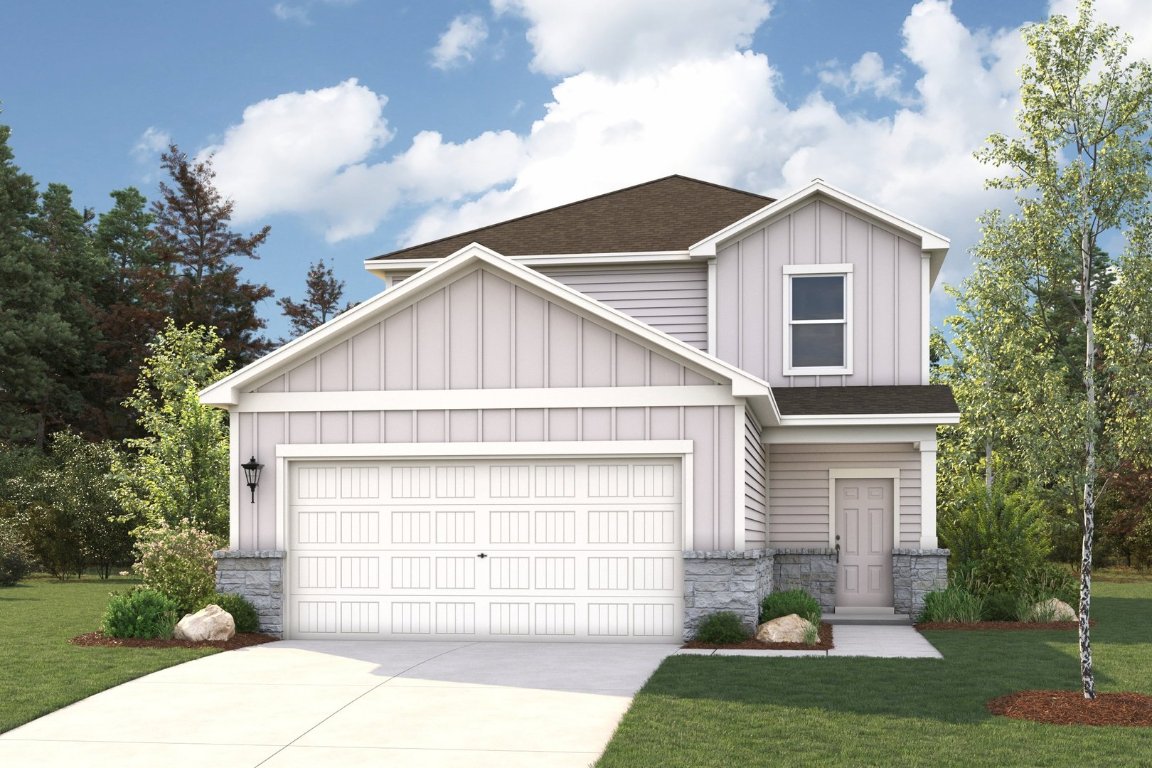 a view of a white house next to a yard and a large tree