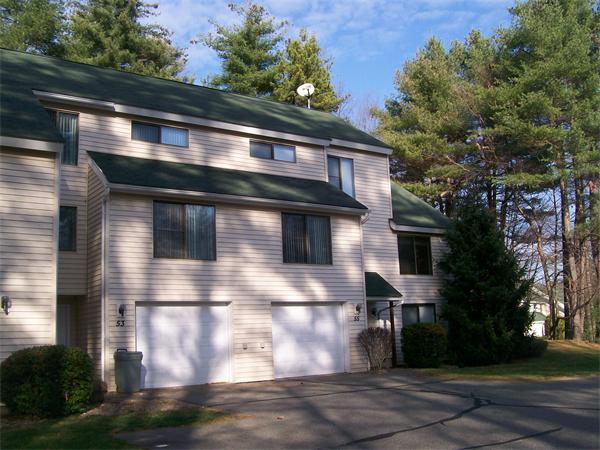 55 Ridgewood Drive, Unit H Atkinson, NH 03811 - Photo 1 of 1 a front view of a house with yard