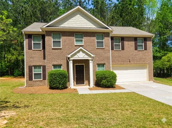 a front view of a house with a yard