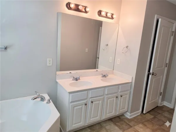 a bathroom with a sink a vanity and a mirror