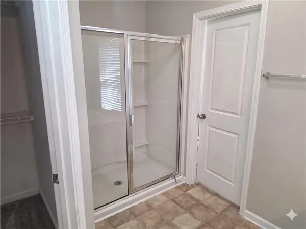 a bathroom with a glass shower door