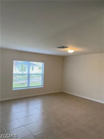 an empty room with a empty space and a window