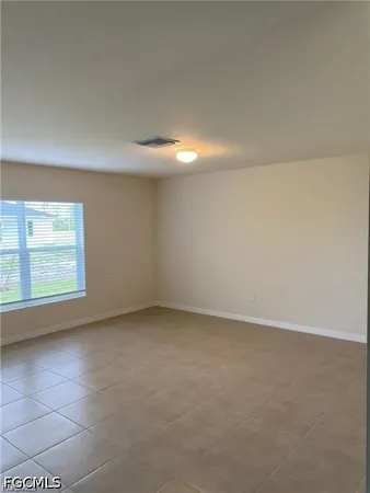 an empty room with a empty space and window