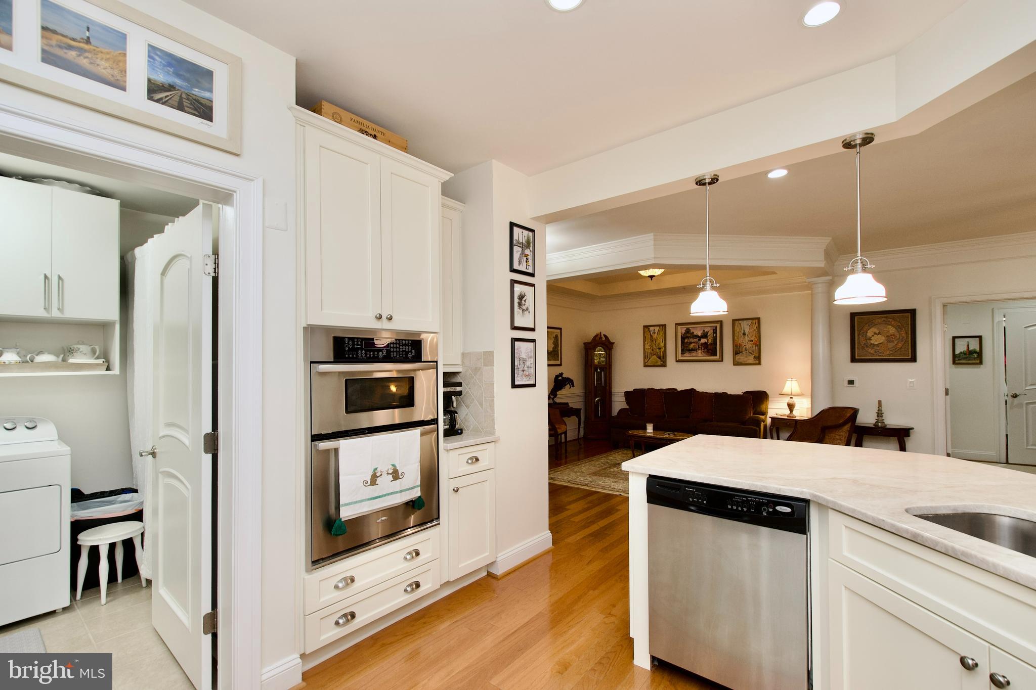 1781 Chain Bridge Road, Unit 302 McLean, VA 22102 - Photo 11 of 39 a kitchen with stainless steel appliances kitchen island granite countertop a refrigerator and a stove top oven