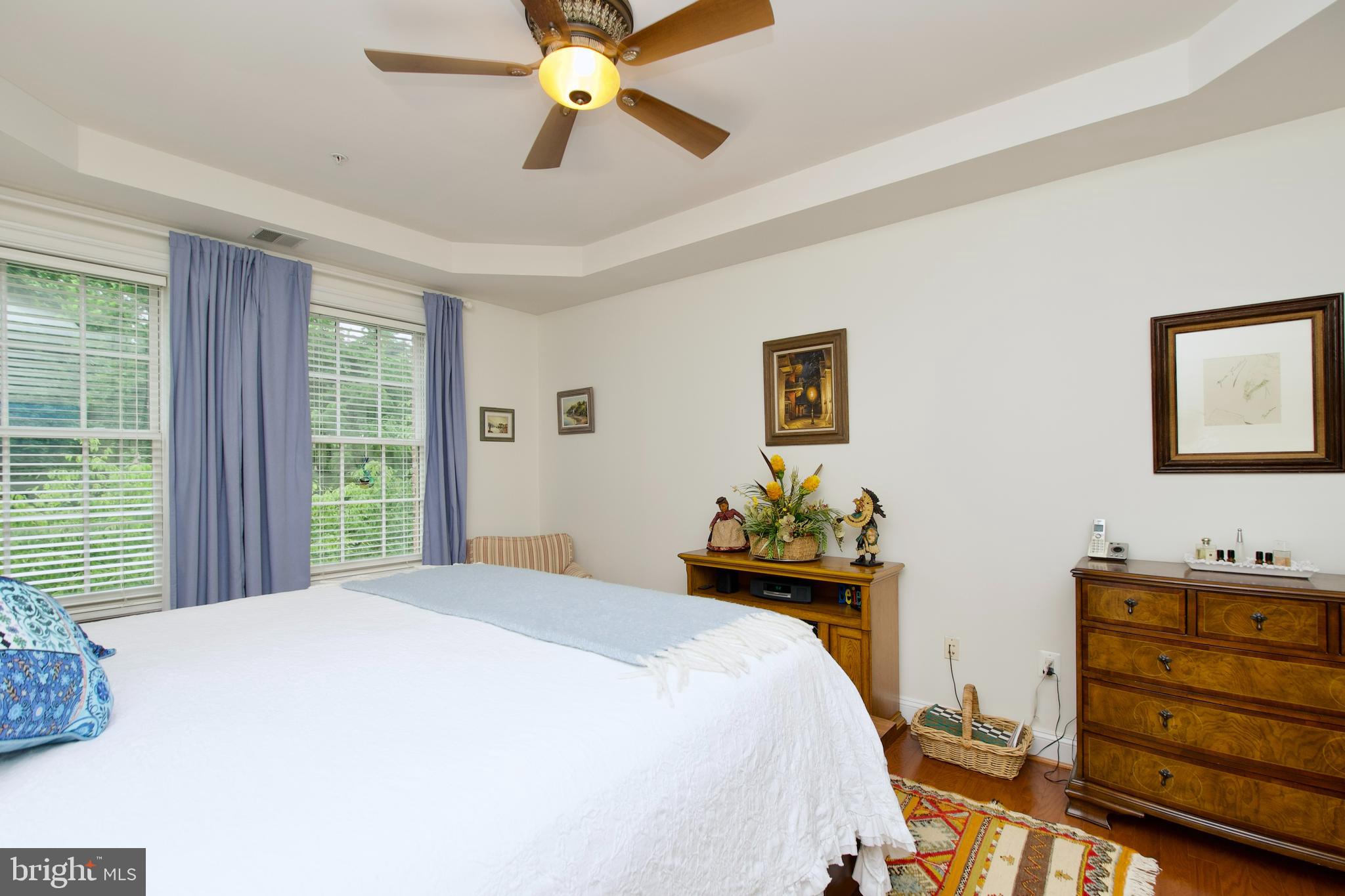 1781 Chain Bridge Road, Unit 302 McLean, VA 22102 - Photo 16 of 39 a bedroom with a bed and a chandelier