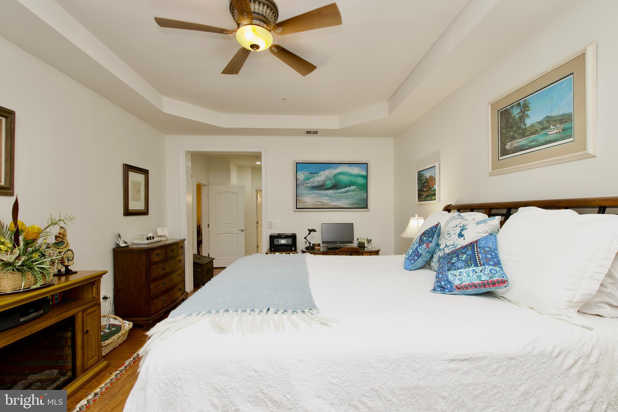 1781 Chain Bridge Road, Unit 302 McLean, VA 22102 - Photo 17 of 39 a bedroom with a bed and wooden floor