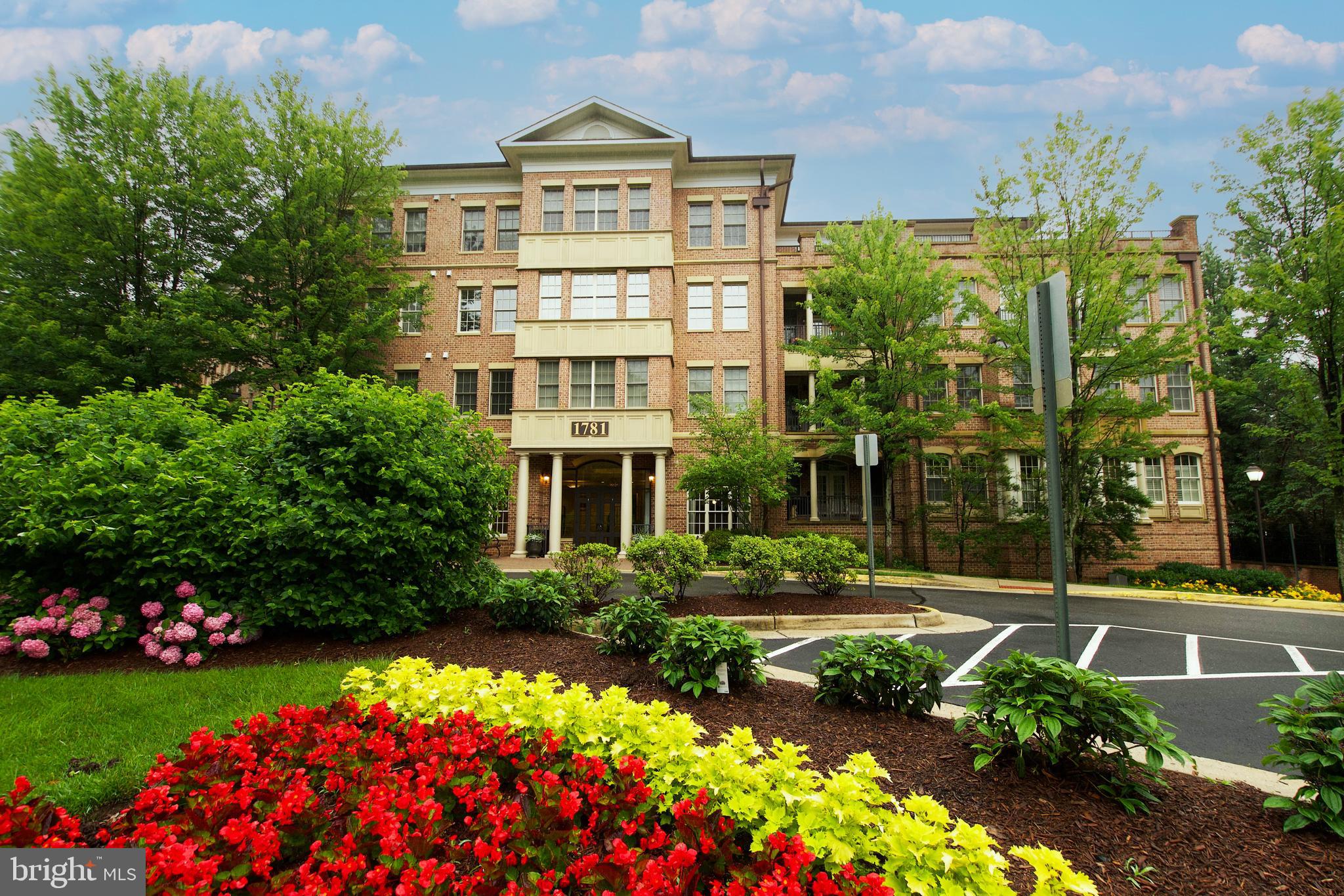 1781 Chain Bridge Road, Unit 302 McLean, VA 22102 - Photo 1 of 39 a front view of a multi story residential apartment building with yard and green space