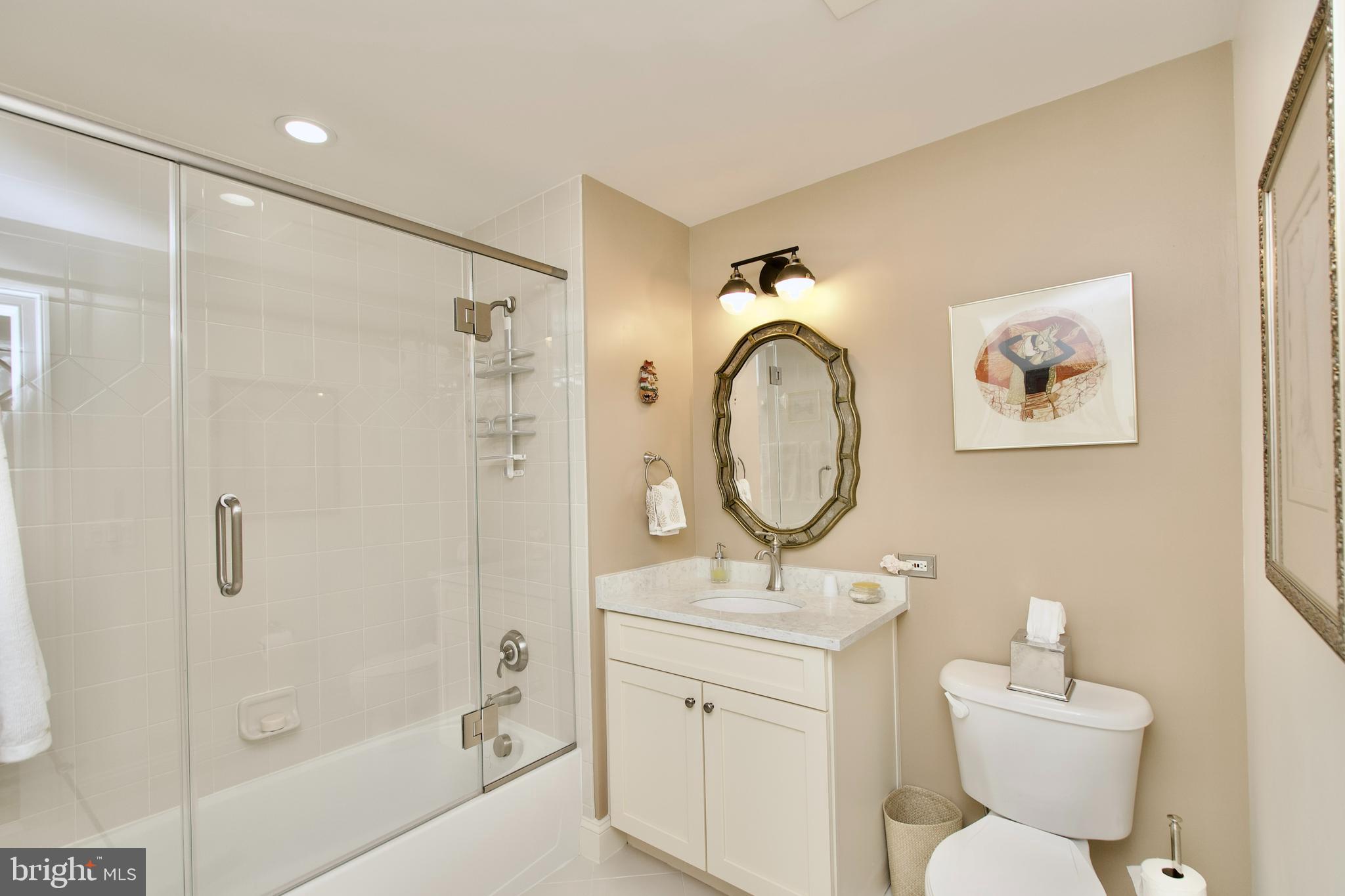 1781 Chain Bridge Road, Unit 302 McLean, VA 22102 - Photo 24 of 39 a bathroom with a toilet sink and shower