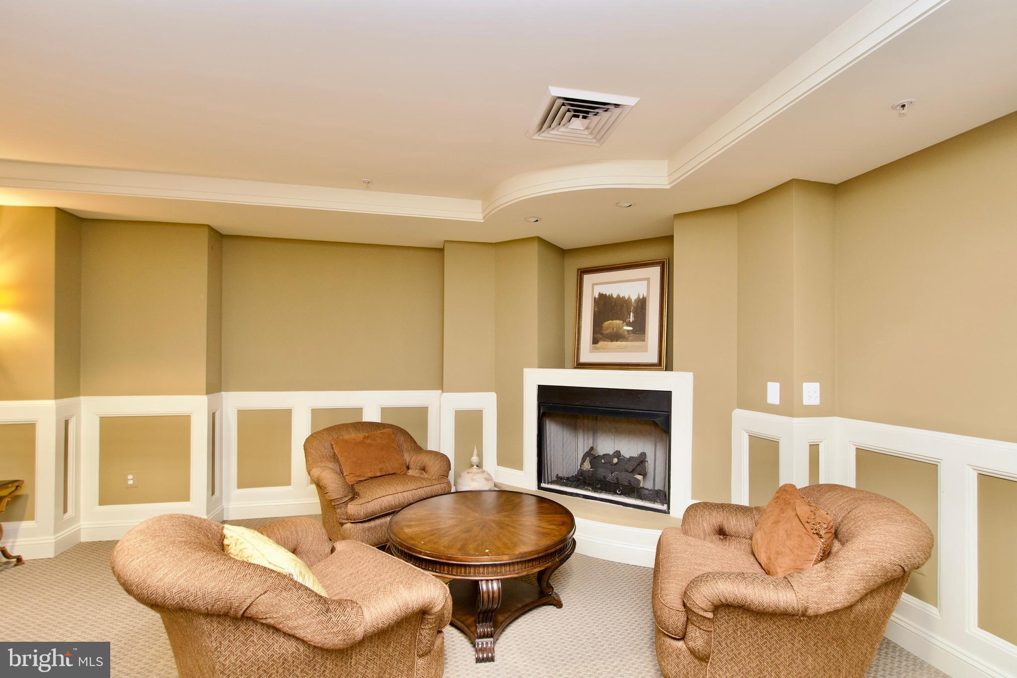 1781 Chain Bridge Road, Unit 302 McLean, VA 22102 - Photo 31 of 39 a living room with fireplace furniture and a large window