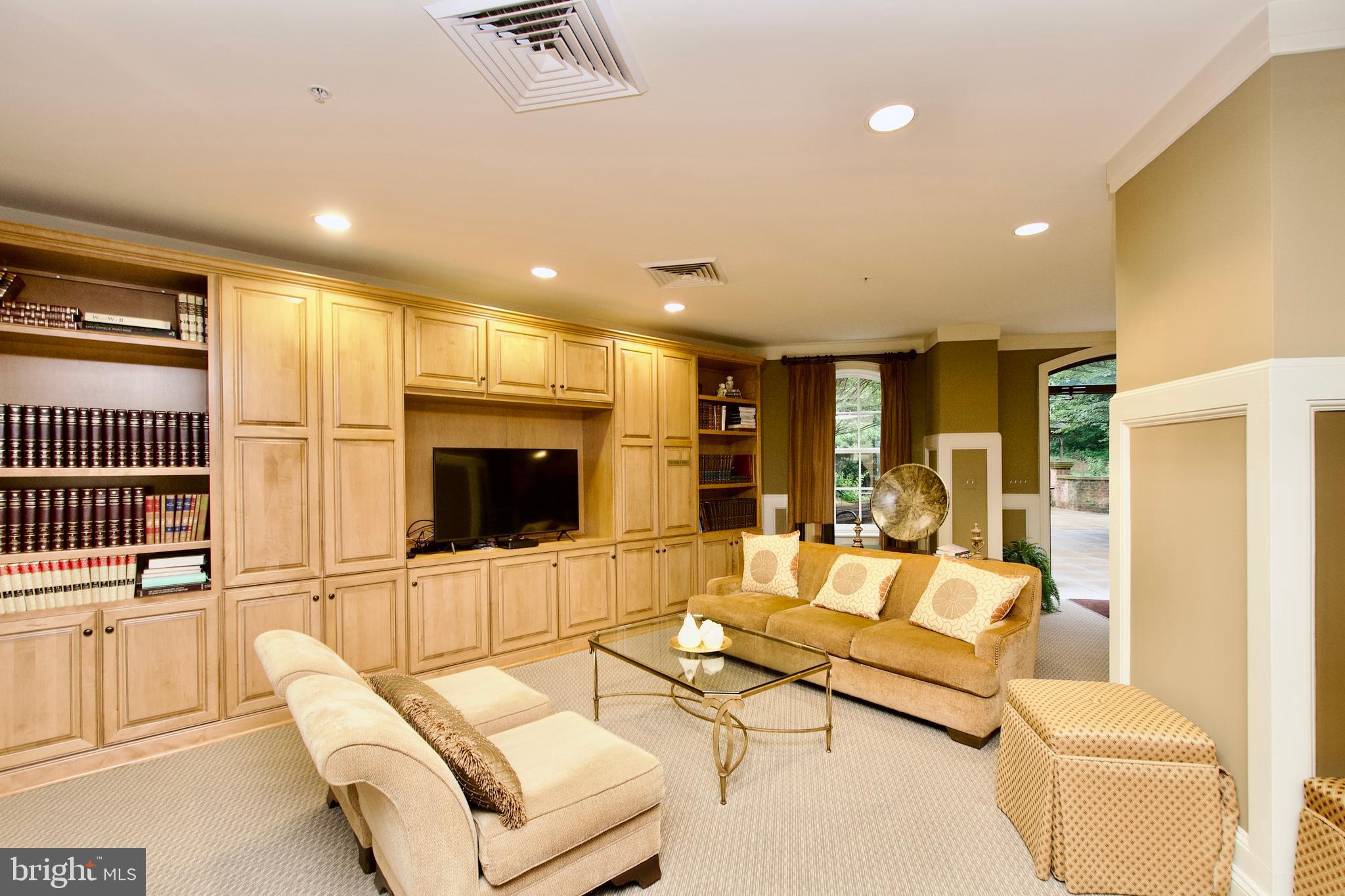 1781 Chain Bridge Road, Unit 302 McLean, VA 22102 - Photo 32 of 39 a living room with furniture and a flat screen tv