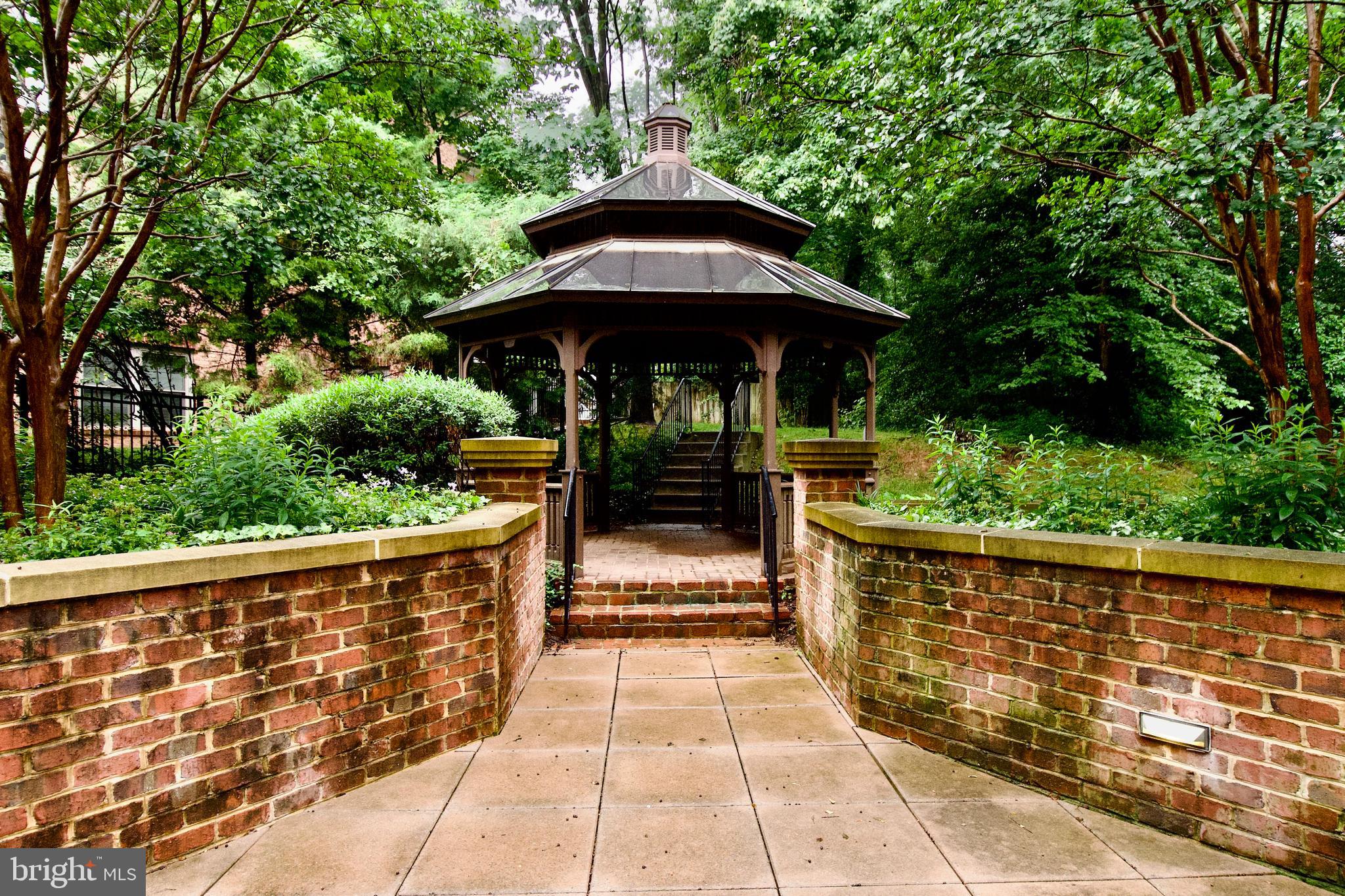 1781 Chain Bridge Road, Unit 302 McLean, VA 22102 - Photo 36 of 39 a view of a chairs and an umbrella in the yard