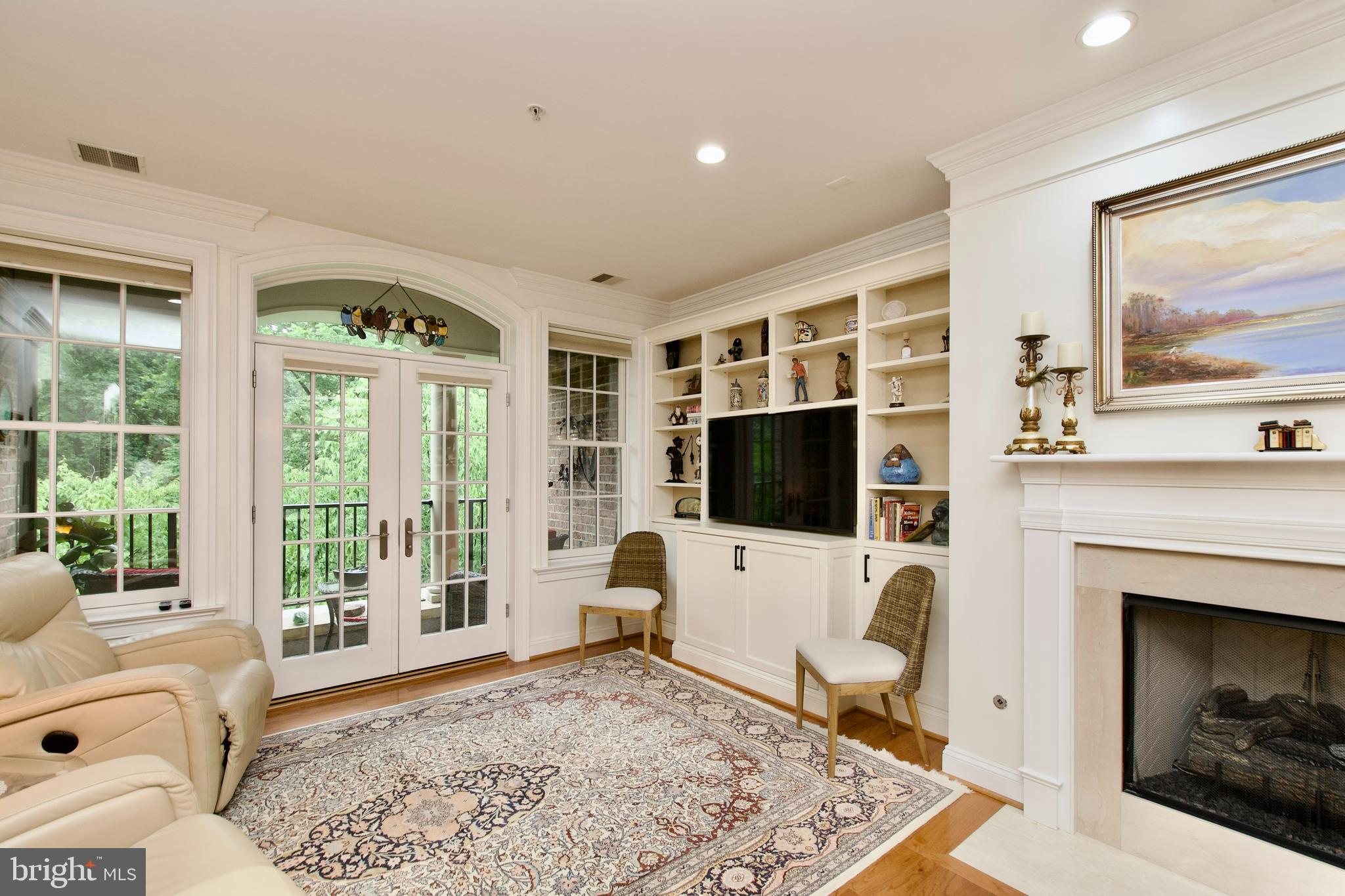 1781 Chain Bridge Road, Unit 302 McLean, VA 22102 - Photo 5 of 39 a living room with furniture and a flat screen tv