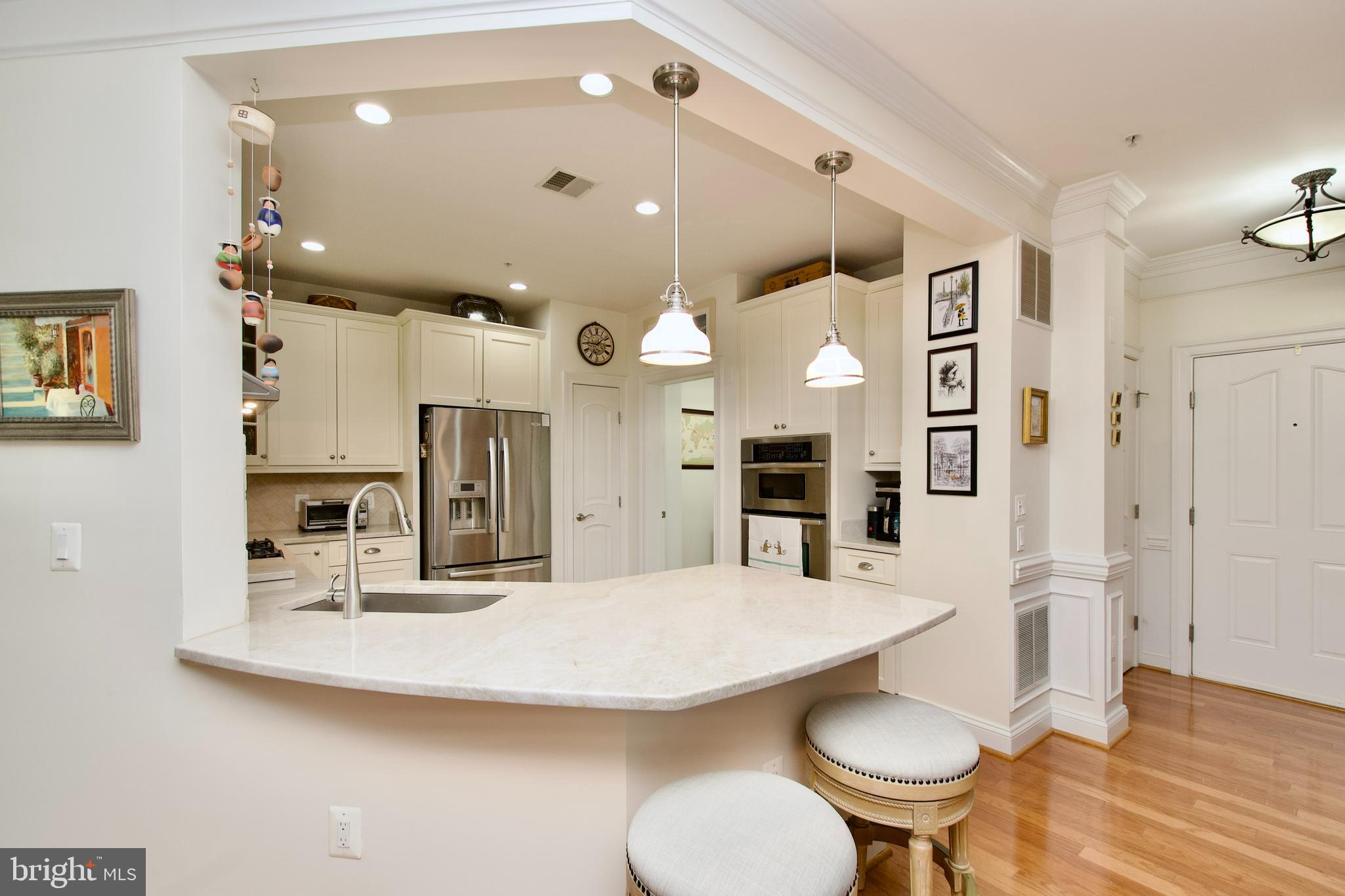 1781 Chain Bridge Road, Unit 302 McLean, VA 22102 - Photo 7 of 39 a large kitchen with a table and chairs