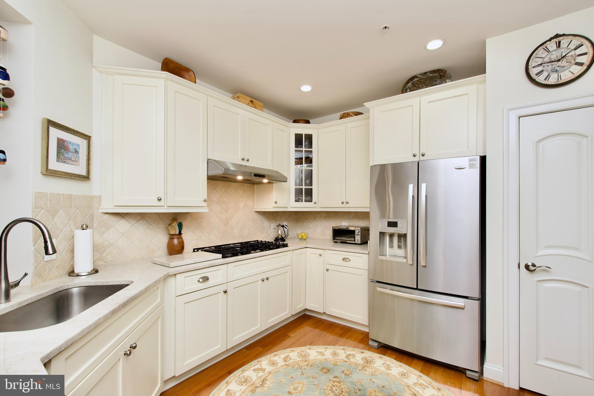 1781 Chain Bridge Road, Unit 302 McLean, VA 22102 - Photo 8 of 39 a kitchen with stainless steel appliances a refrigerator sink and cabinets