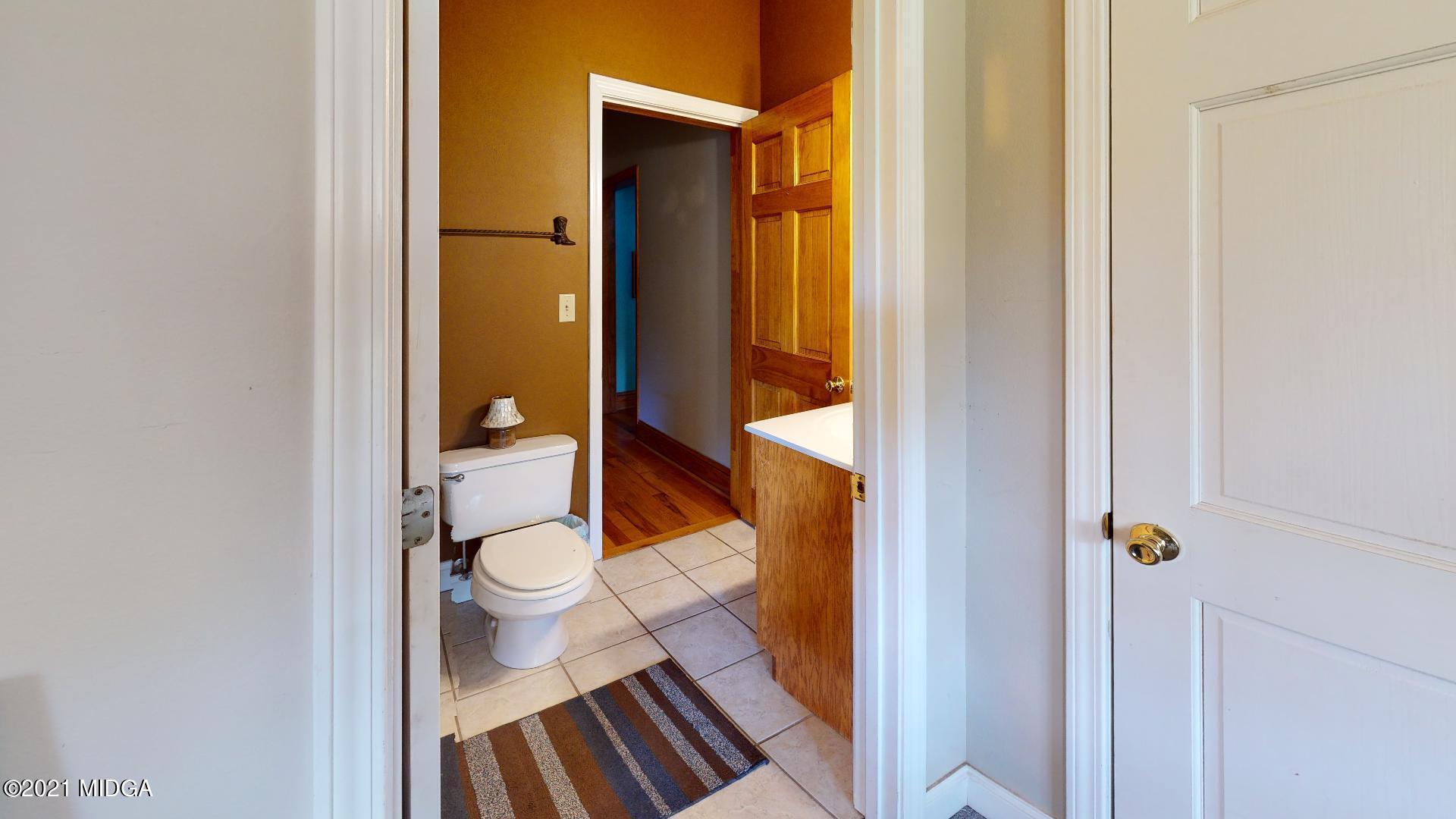 1534 Smith Road Forsyth, GA 31029 - Photo 11 of 25 a bathroom with a toilet and a shower curtain